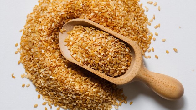 Sesame seeds in wooden scoop isolated on white organic dry sesame seeds