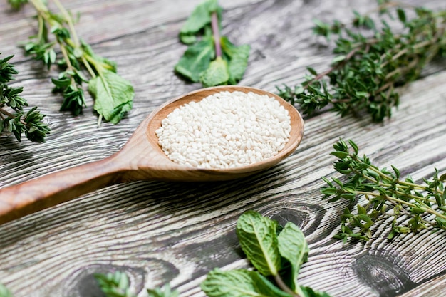 Sesame seeds in a wooden spoon on rustic background healthy diet Top view