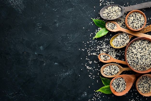 Sesame Set of black and white sesame seeds On a black background Top view Free copy space