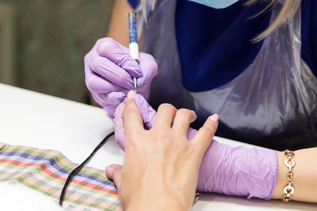 Session of the manicure in the beauty salon.