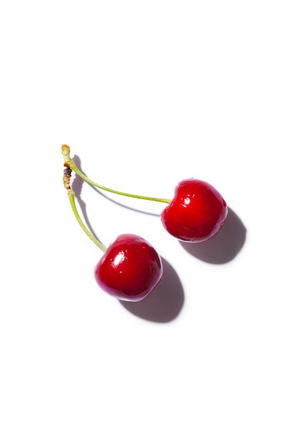 Photo set of 2 cherries on white background with copy space