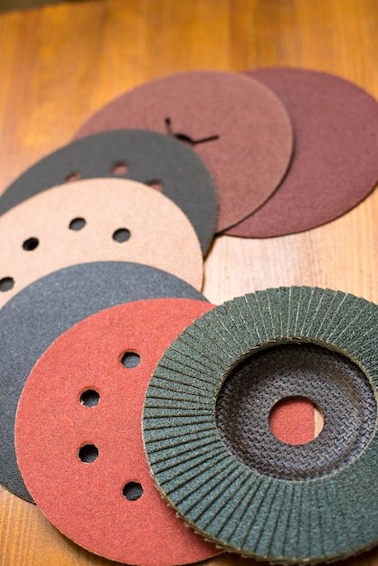 Photo set of abrasive materials on wooden background vertical view