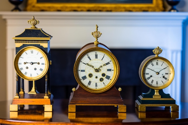 A set of antique clocks representing the history of timekeeping