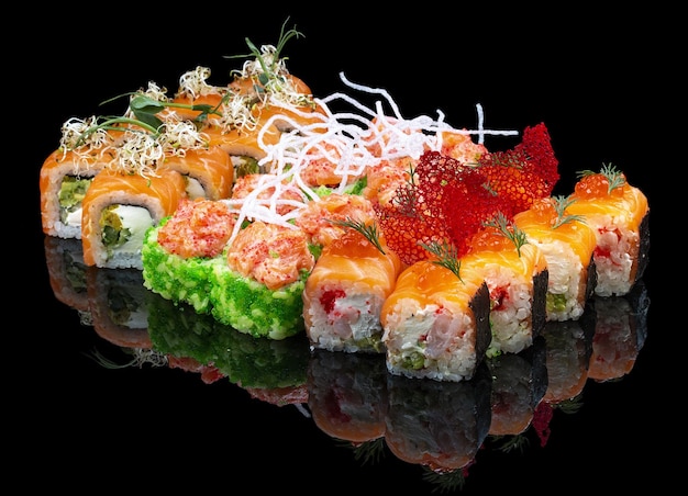 A set of assorted large sushi rolls on a glossy black background