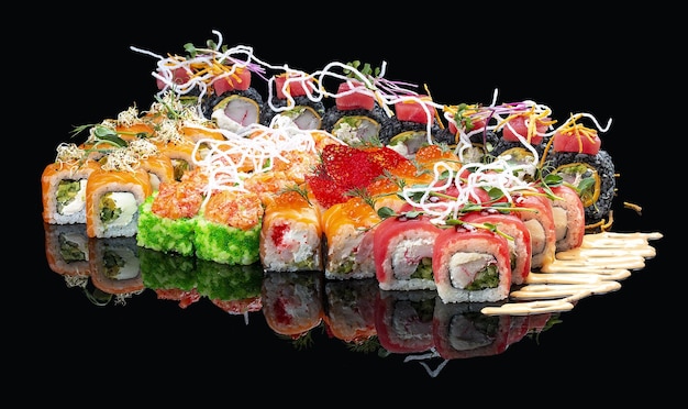 A set of assorted large sushi rolls on a glossy black background