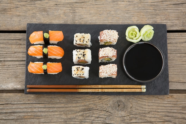 Set of assorted sushi served on black stone slate