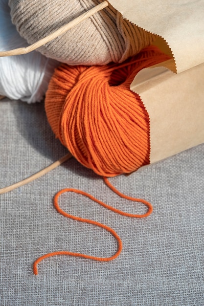 A set of balls of knitting threads in a paper craft bag, close-up.