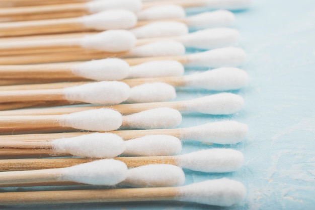 Set of bamboo cotton buds on a blue background. Wooden cotton buds for ear. Zero waste