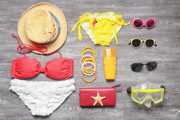 Set of beach accessories on wooden background Summer vacation concept