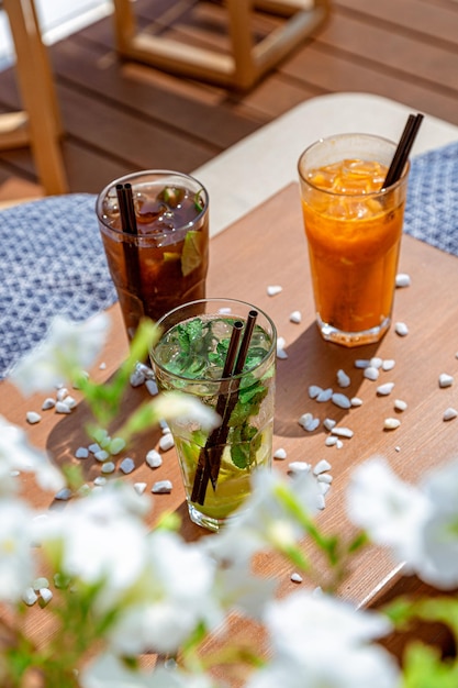 A set of beautiful lemonades on the summer table Summer soft drinks