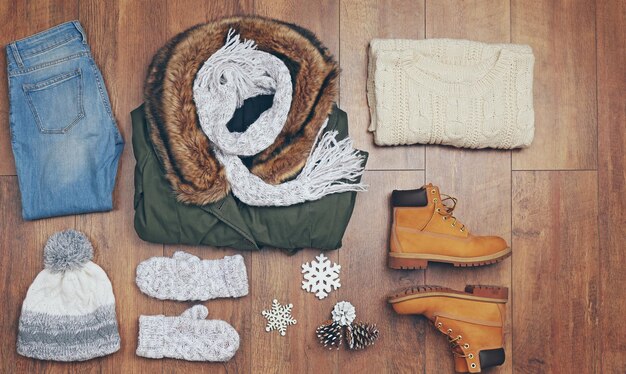 Photo set of beautiful winter female clothes on wooden background