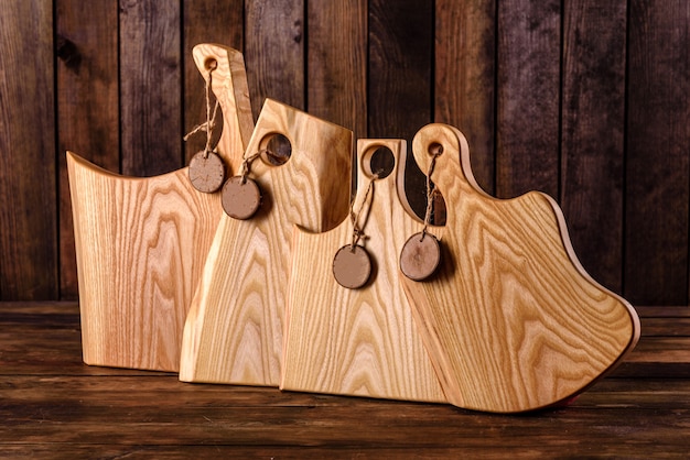 Set of beautiful wooden cutting boards on a wooden table. Cooking in the kitchen