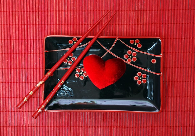 Set of black chinese ceramics kitchen utensils and red heart