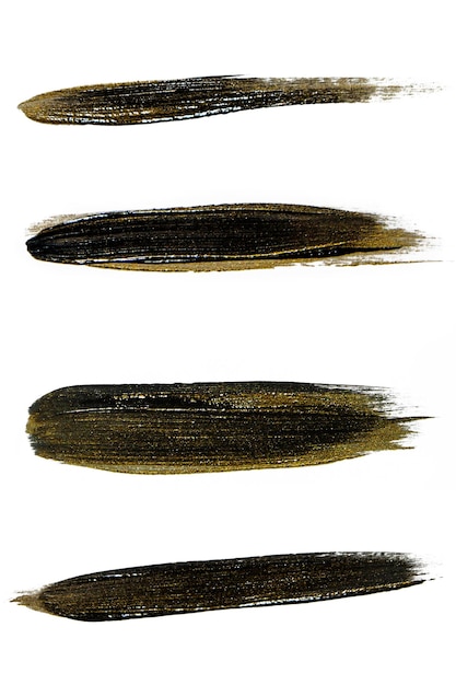 Набор мазков черной краской с золотом на белом фоне