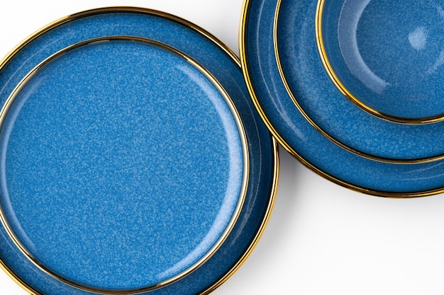 A set of blue ceramic plates on a white background Top view