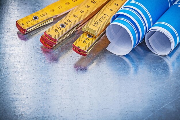 Set of blue construction drawings wooden meter on metallic background