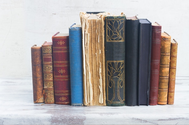 Set of books on white wooden desktop