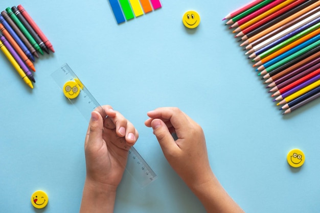 A set of bright stationery items on a blue background Colour pencils