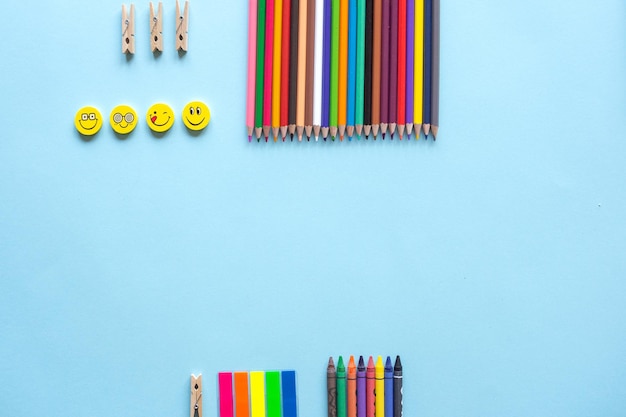 A set of bright stationery items on a blue background colour\
pencils