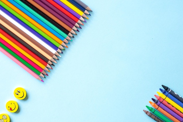 Photo a set of bright stationery items on a blue background colour pencils