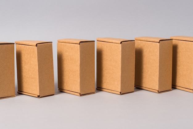 Set of brown cardboard boxes on grey background