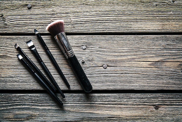 Set of brushes for makeup on wooden