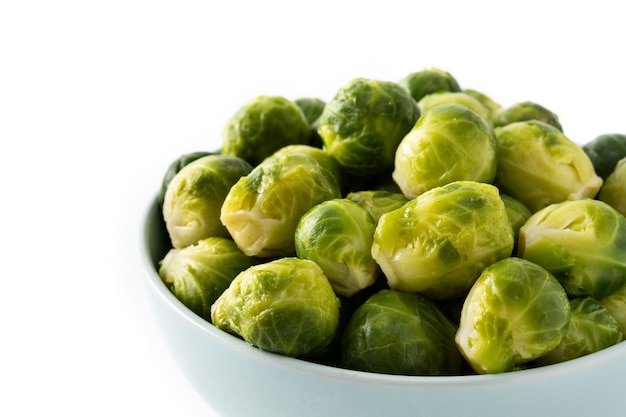 Set of brussel sprouts in a bowl isolated on white background