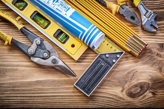 Set of building tools on vintage wooden board.