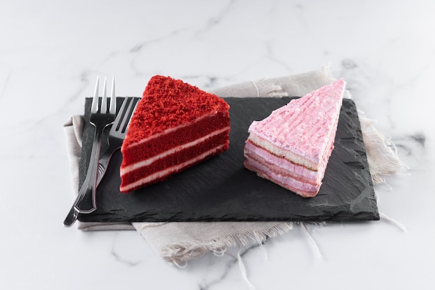 Set of cake portions velvet and strawberry cake on marble