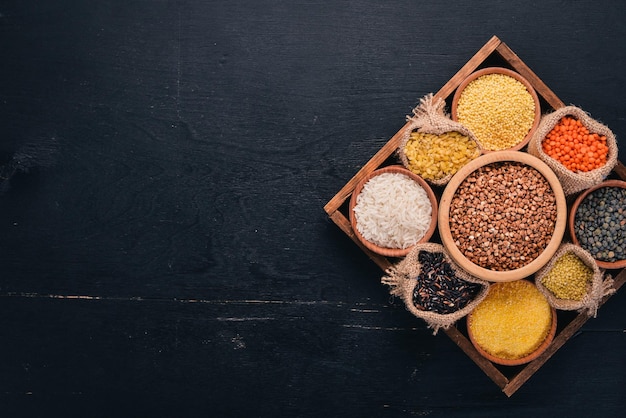 A set of cereals and grains in a wooden basket on a wooden background Top view Copy space