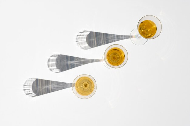 Set of champagne glasses with long shadow behind