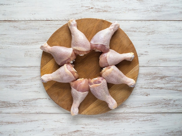 Set of chicken thighs before cooking. Chicken legs on a cutting board.