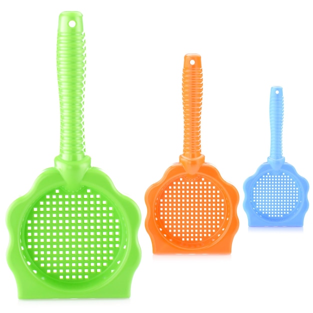 A set of children's colorful plastic sieve for playing in the sandbox Color sieve isolated on a white background closeup