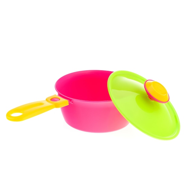 A set of children's toy dishes isolated on a white background Plastic frying pan lid and spatula Children's kitchen Educational roleplaying games for children