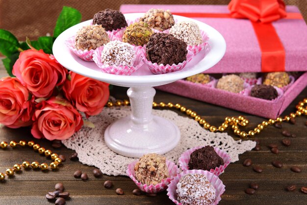 Set of chocolate candies on table on brown background