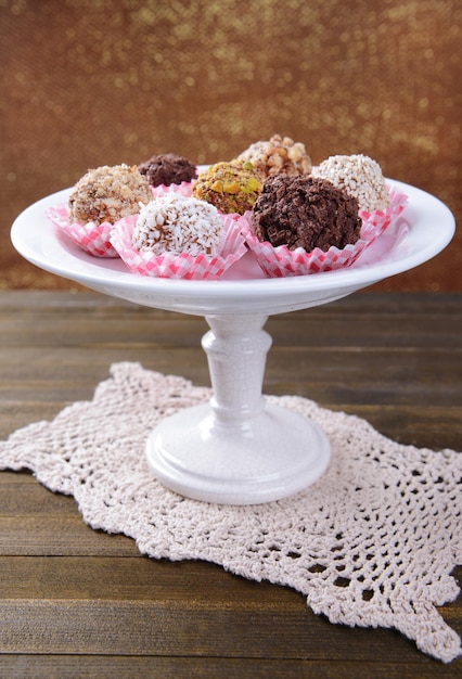 Set of chocolate candies on table on brown background