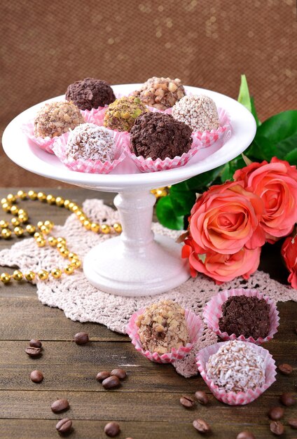 Set of chocolate candies on table on brown background