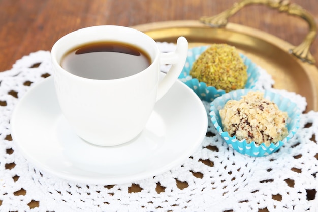 Set of chocolate candies, on tray, on wooden background