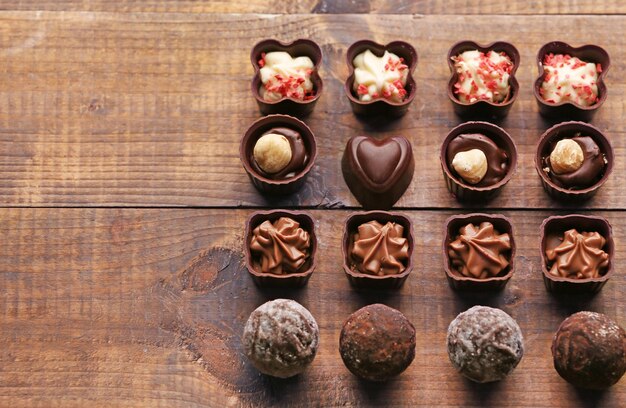 Set of chocolate candies on a wooden background