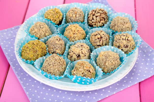 Set of chocolate candies, on wooden background