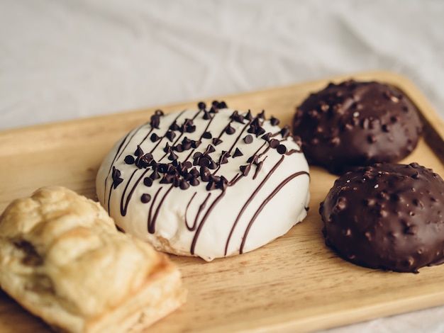 Set of chocolate donuts and puff pie.