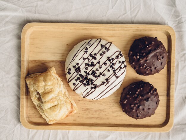 Set of chocolate donuts and puff pie