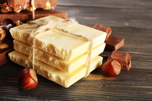 Set of chocolate with hazelnut on wooden table closeup