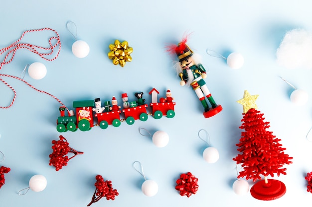 Photo set of christmas decorations with nutcracker, toy train and balls