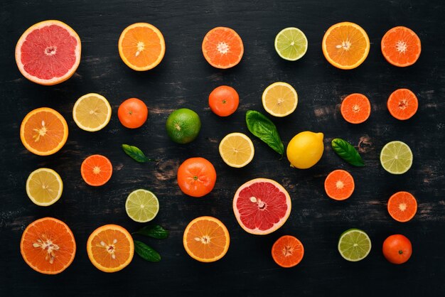 A set of citrus fruit Orange tangerine grapefruit lemon On a wooden background Top view Copy space