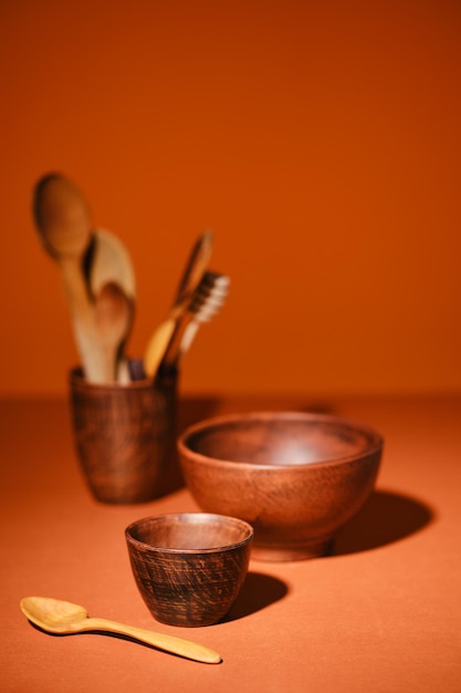 Set of clay bowls on orange background