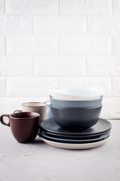 Set of clean tableware on gray concrete