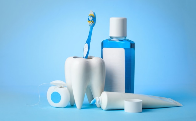 Set for cleaning teeth and mouth Toothpaste toothbrush dental floss and mouthwash on blue