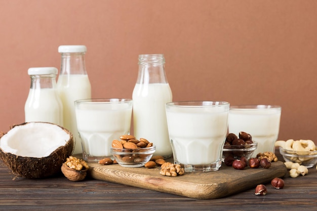 Set or collection of various vegan milk almond coconut cashew on table background Vegan plant based milk and ingredients top view