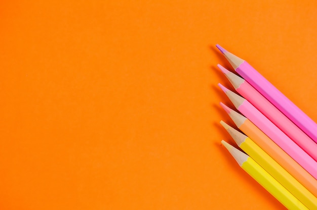 Set of color pencils for drawing on a orange background